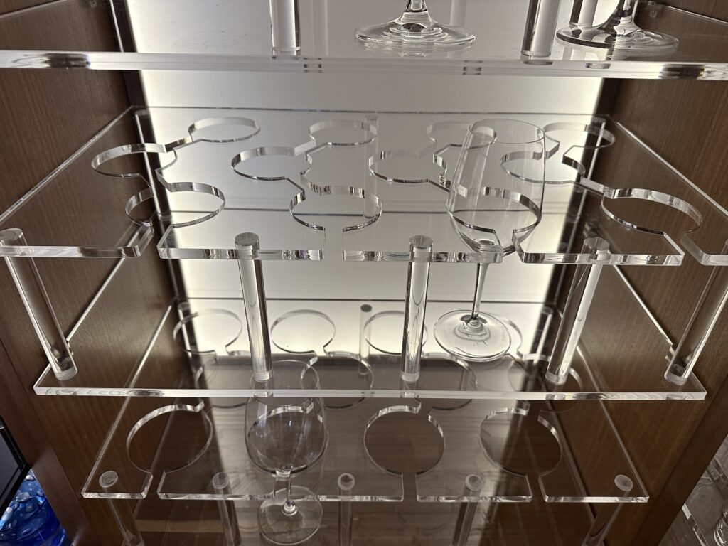 Alt text: "Acrylic perspex shelving with glass and cutlery display"